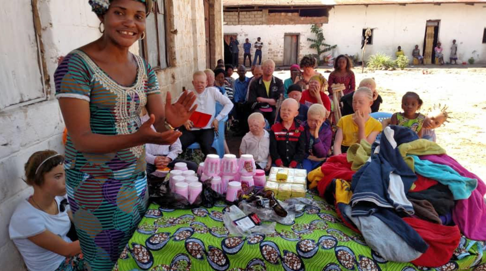 A group of people sitting around a table with cups.