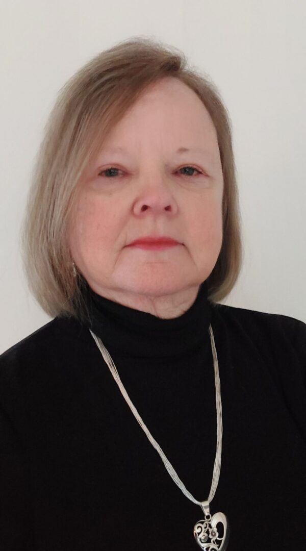 A woman with short hair wearing a black shirt.